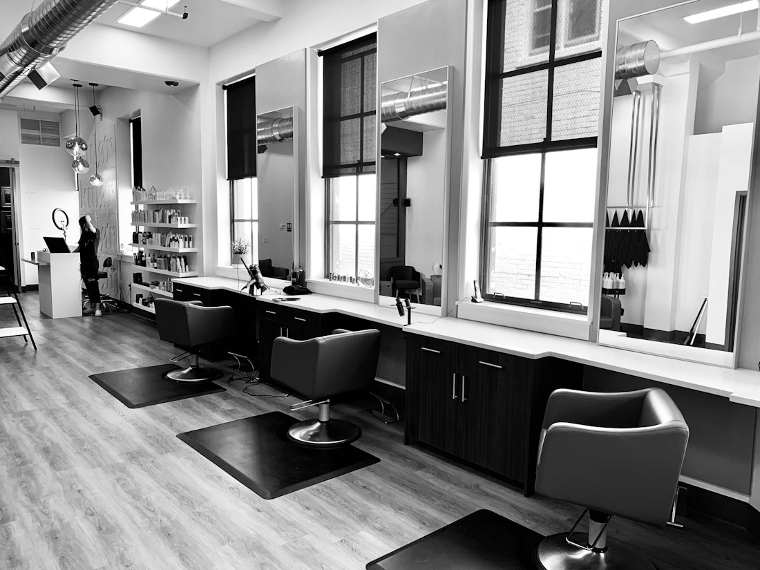 A bright salon with a row of styling stations